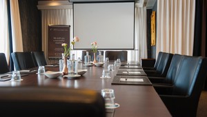 Boardroom in block setup with TV screen and flipchart